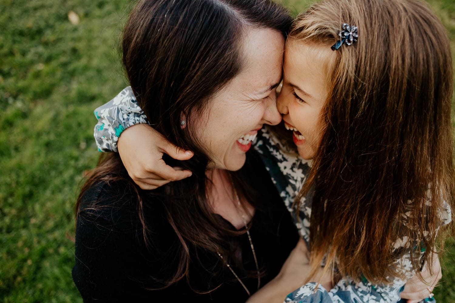 Closeup of mom and daughter with foreheads together laughing - Clackamas Oregon Photographer
