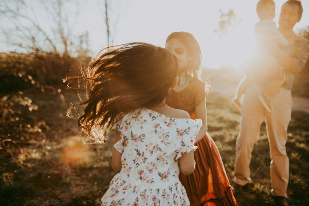 sisters dancing together in the sunset light - pdx lifestyle photography