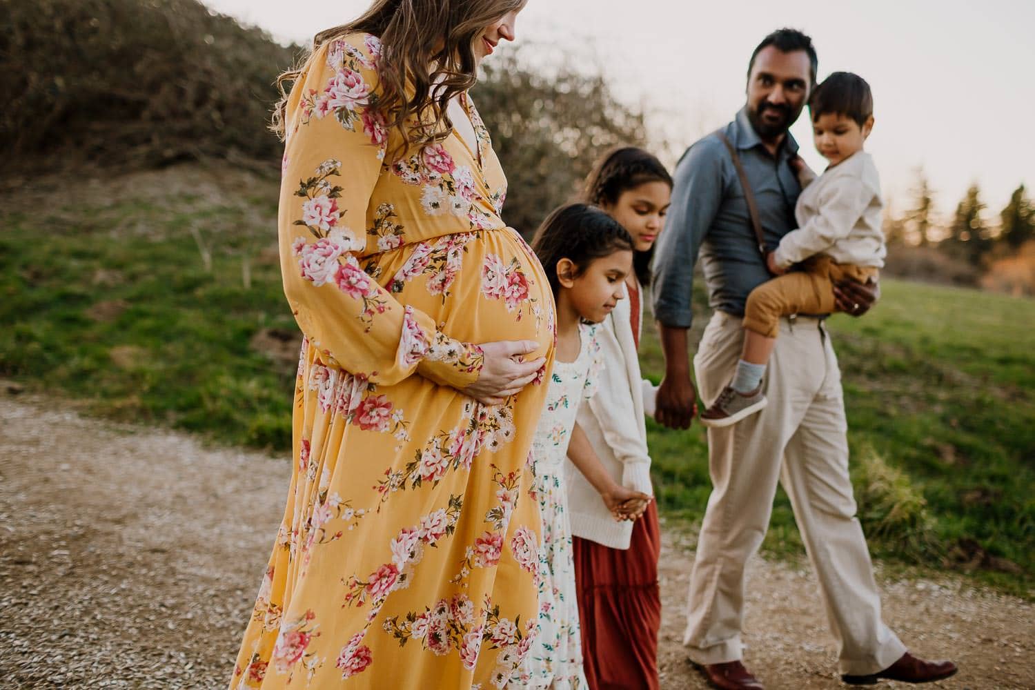Maternity photo of family walking together in Portland