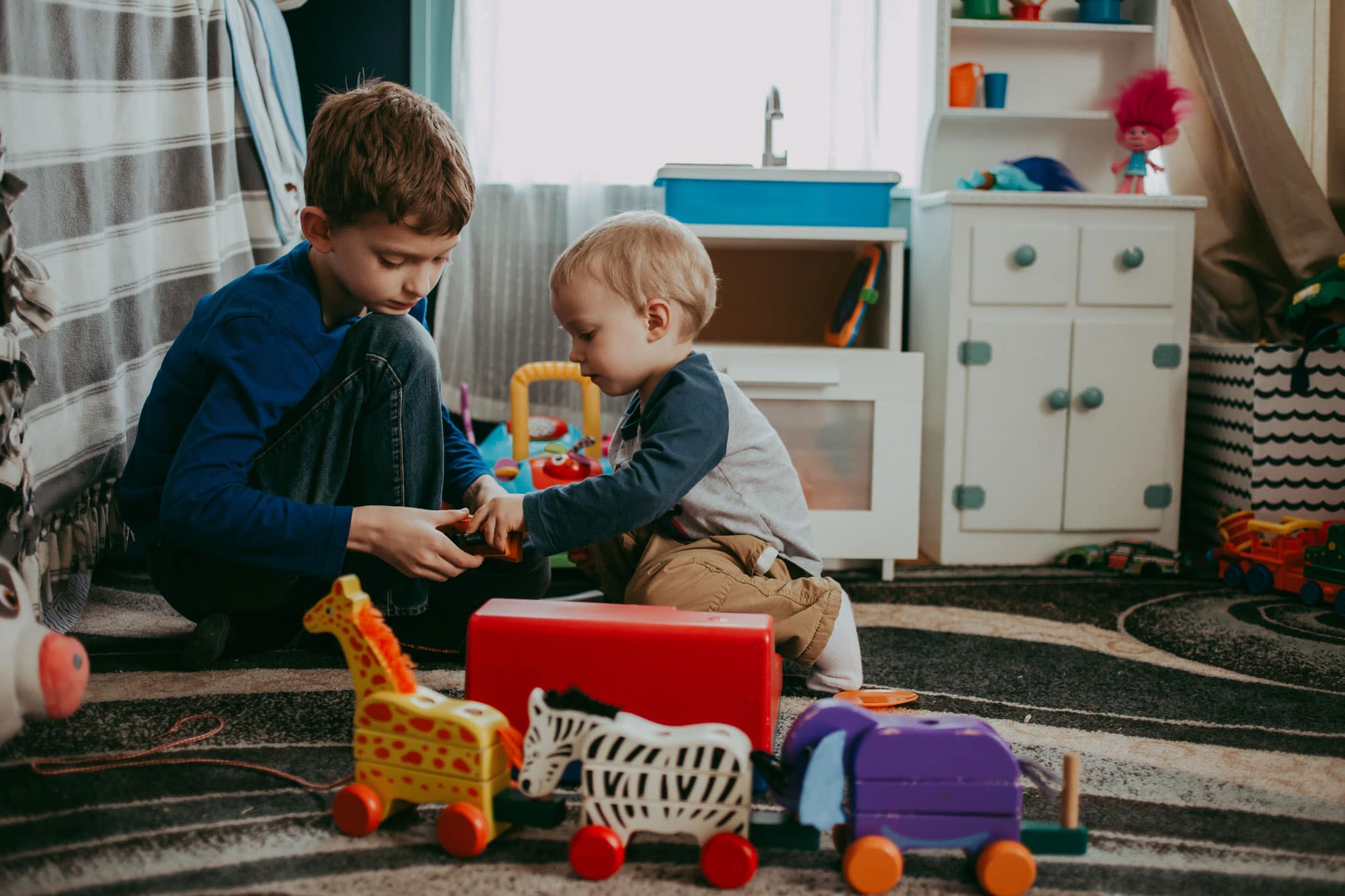 Documentary image of two boys playing with toys - Family Photography