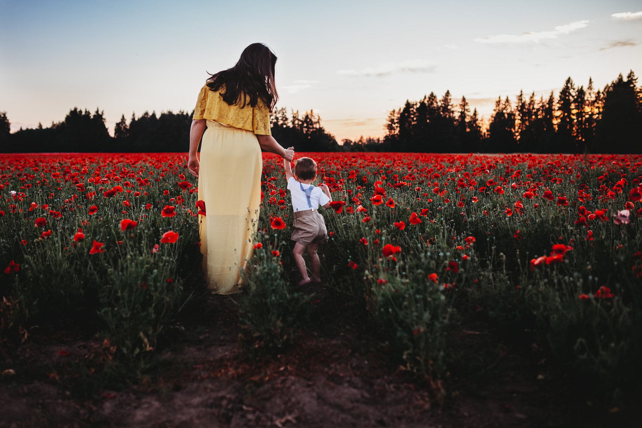 Mom in yellow dress holding hand of toddler wearing suspenders - Poppy Fields in Oregon