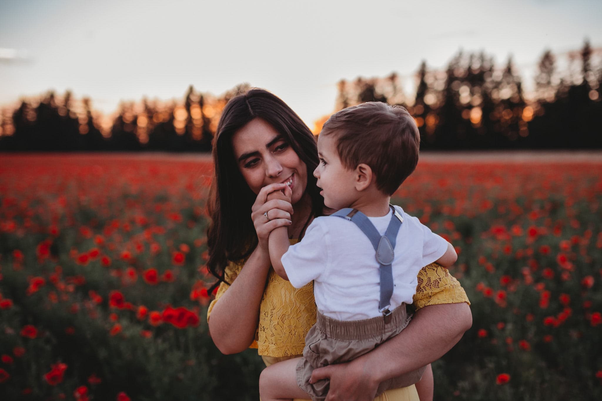 Mom kissing son's hand in Poppy Fields