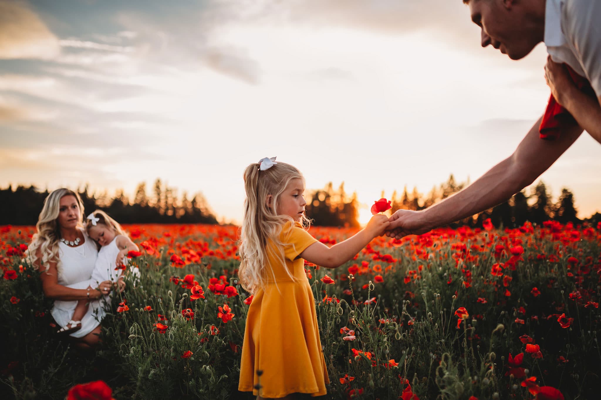 Dad giving poppy to daughter