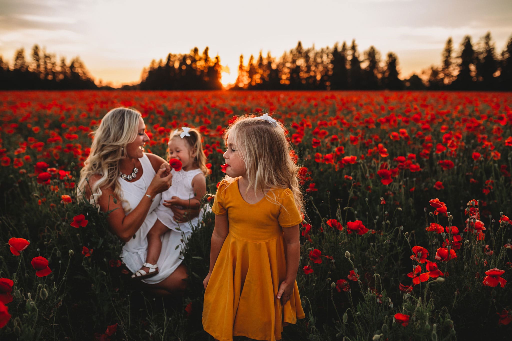 Mom and daughters in poppy field in Oregon
