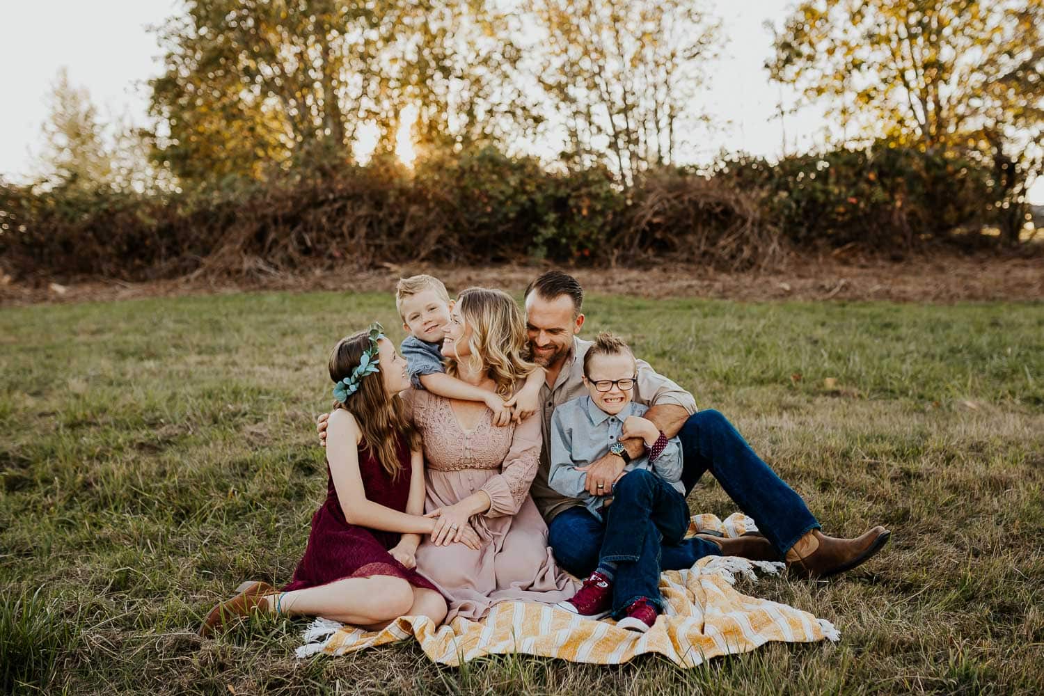 Sweet family of five sitting on blanket during photo session