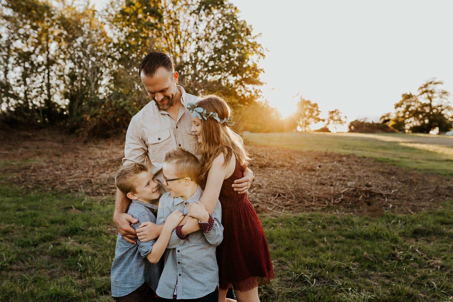 Dad with three kids hugging onto each other - happy valley family photos