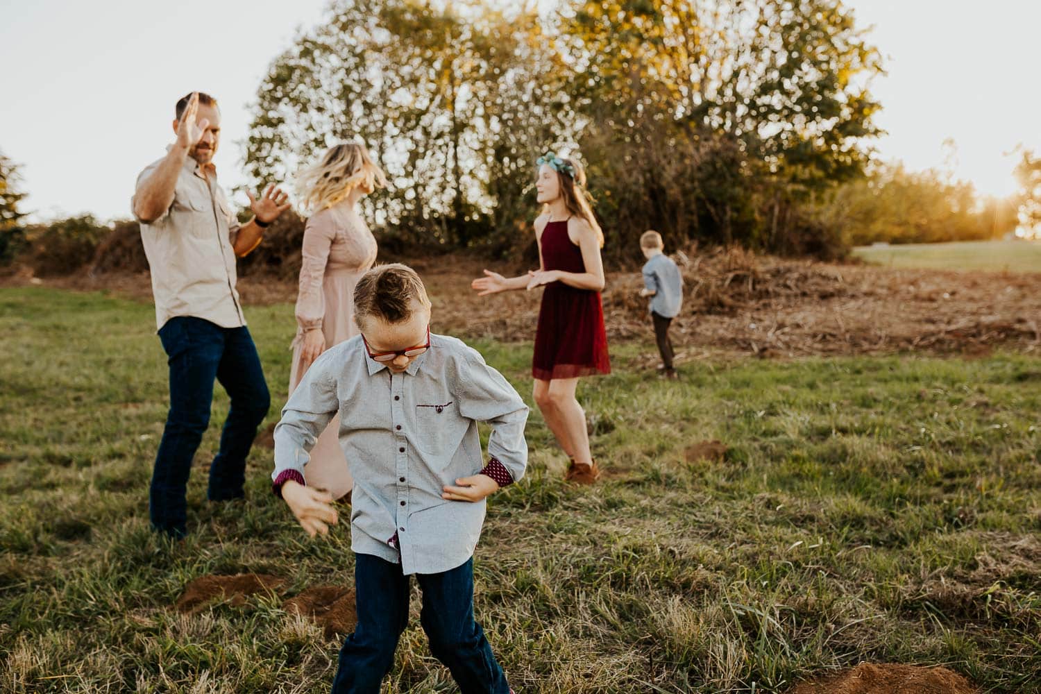 Family of five dancing outside together