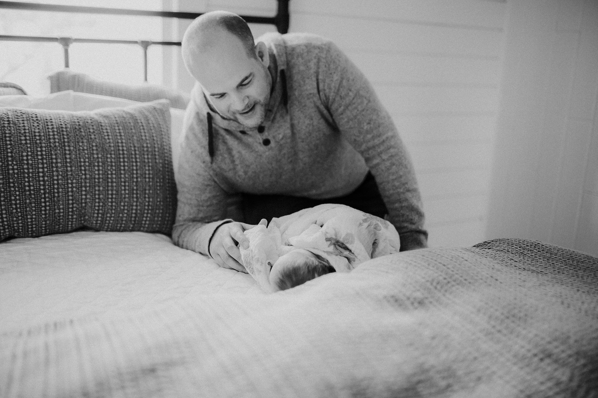 dad and baby on bed