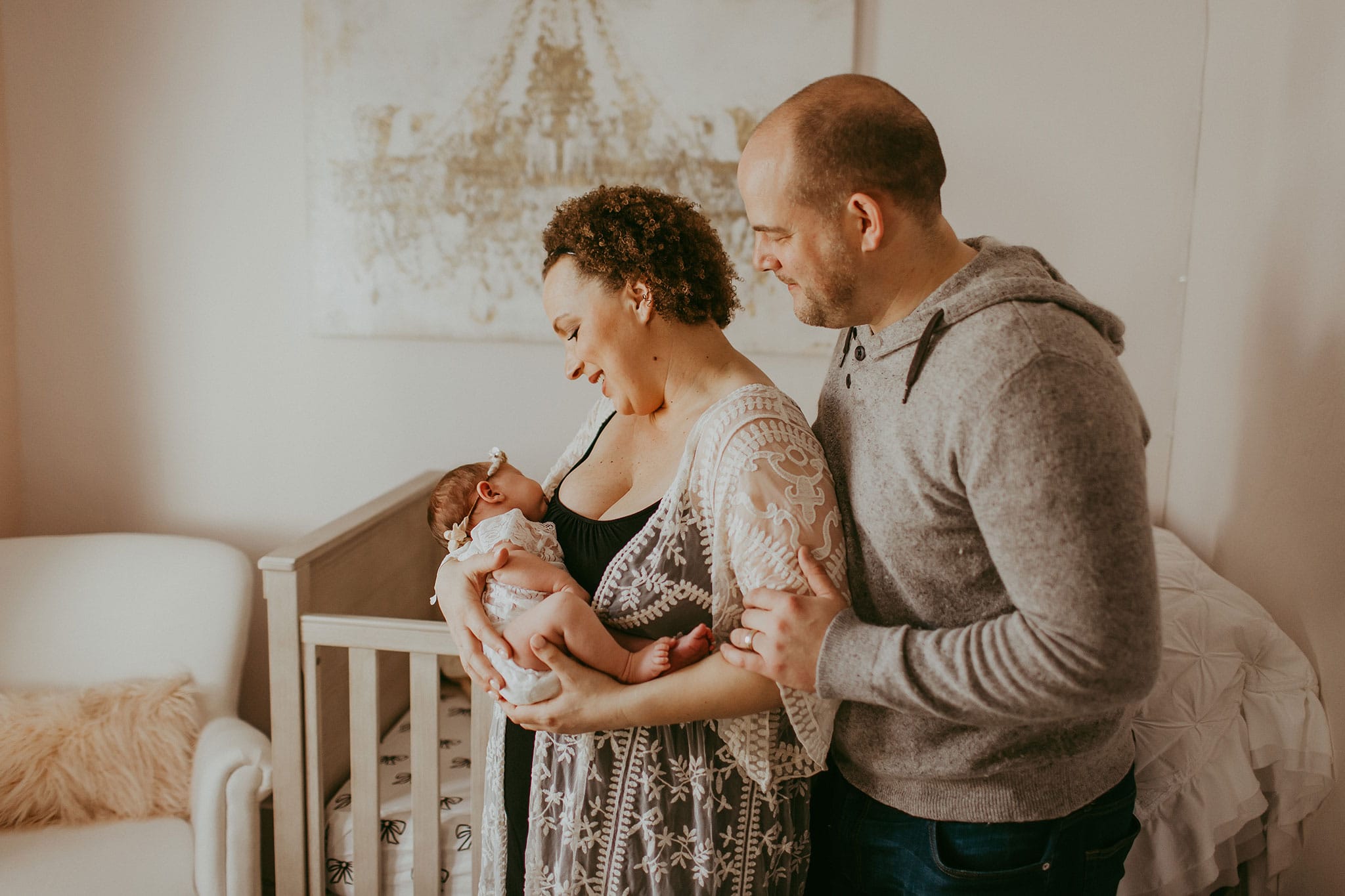 Couple looking at their newborn baby during photography session 