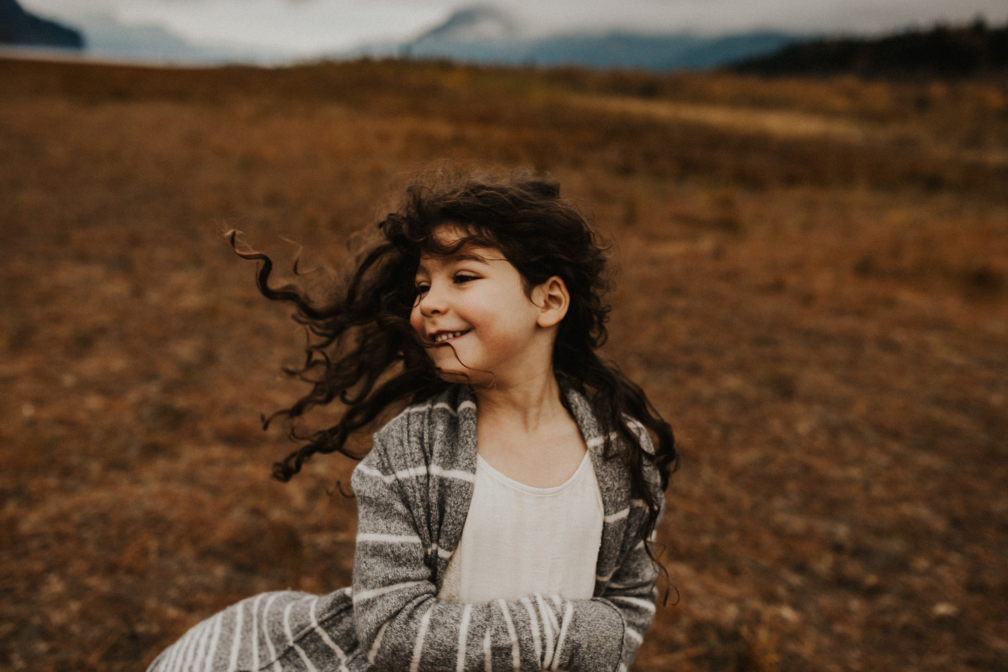 little girl running with hair flying - fall family photos