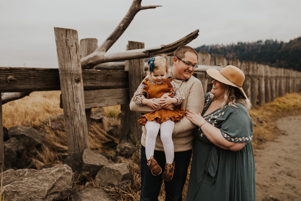fall family photos next to wooden fence - best portland fun family photographer