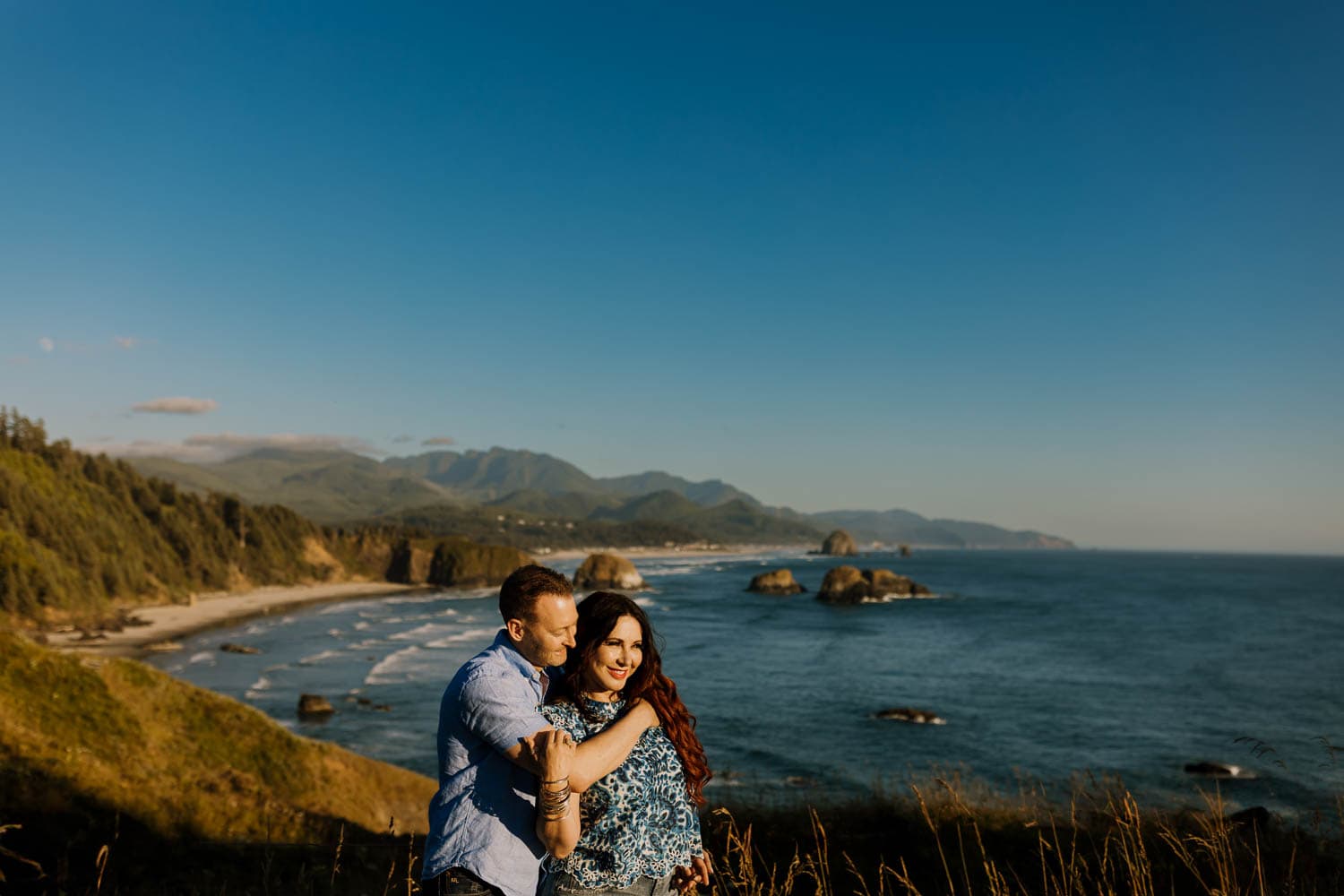 married couple embracing on the Ecola State Park overlook viewpoint