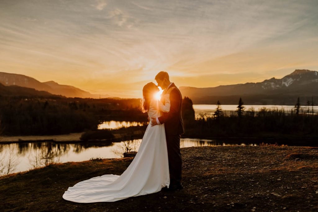 beautiful sunset image of a couple and the glowing sun between them