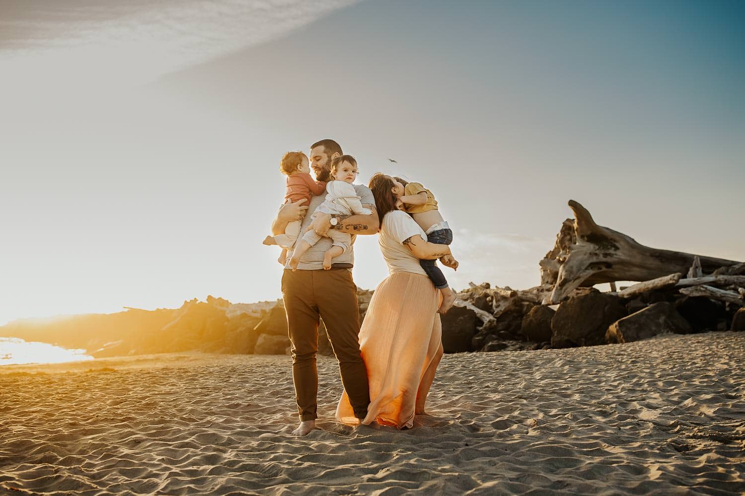Family of five hugging in the sunset on the beach - oregon coast family photographer