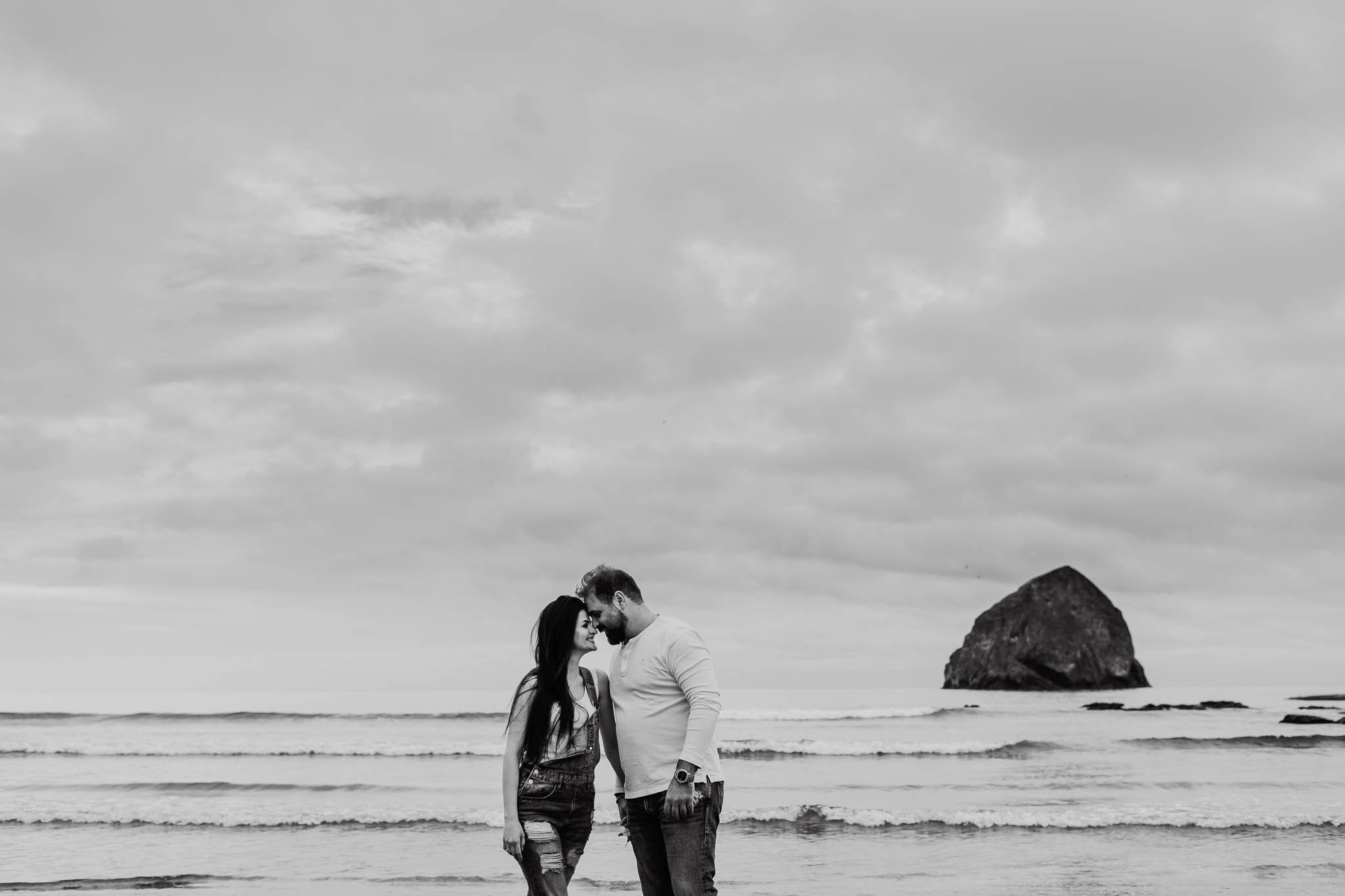 couple with foreheads together at cape kiwanda