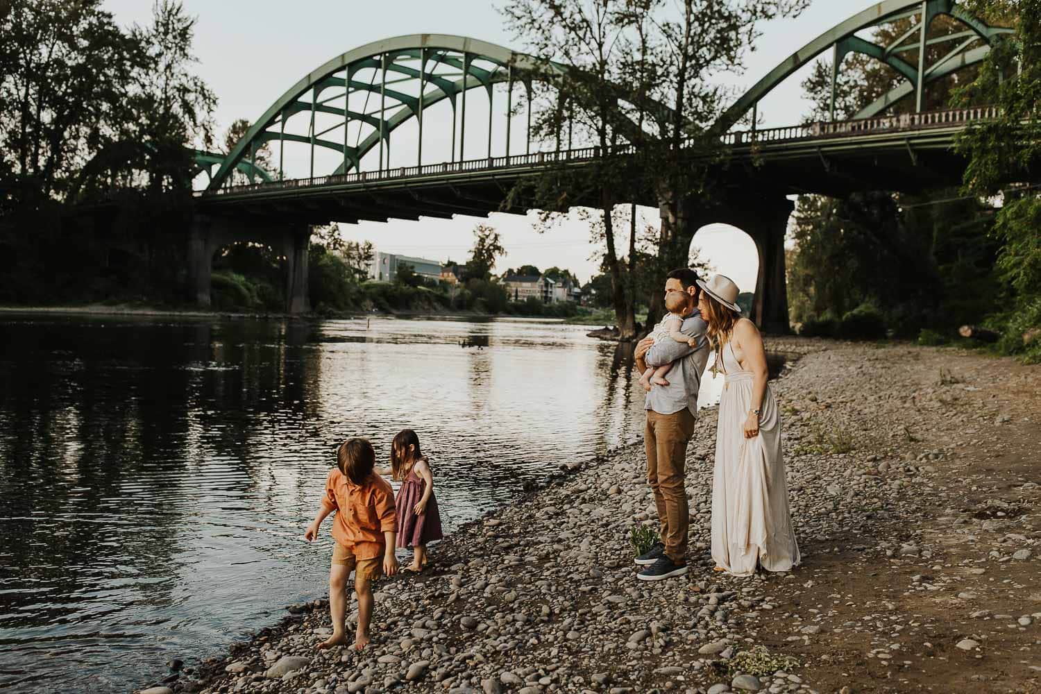 Family hanging out together near green bridge in Oregon City