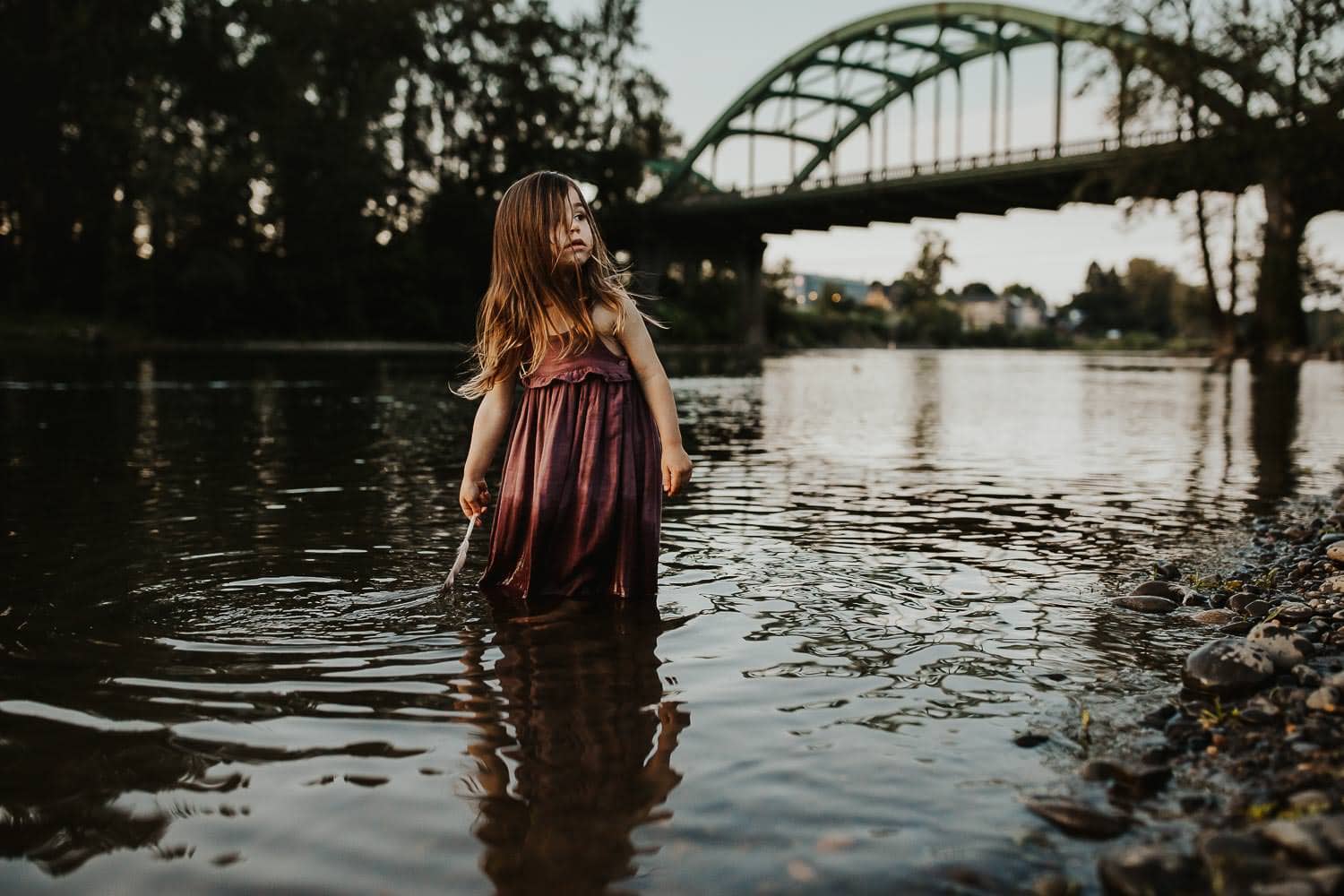 Girl in putple dress standing in river in Oregon City