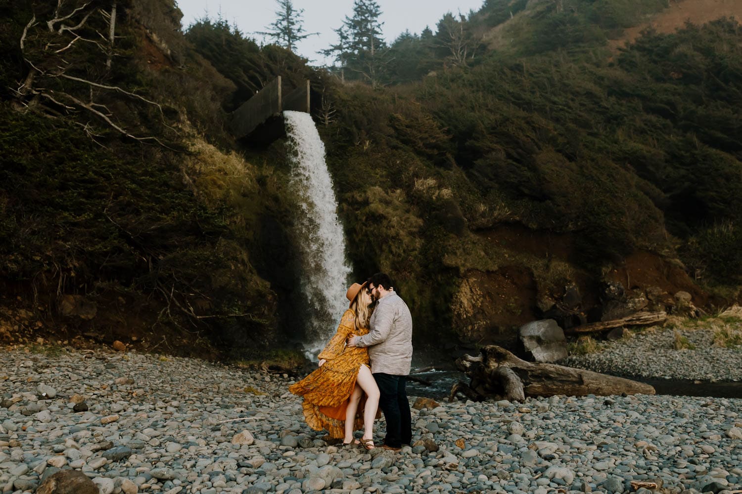 portland couple at a waterfall on the oregon coast during couples photos