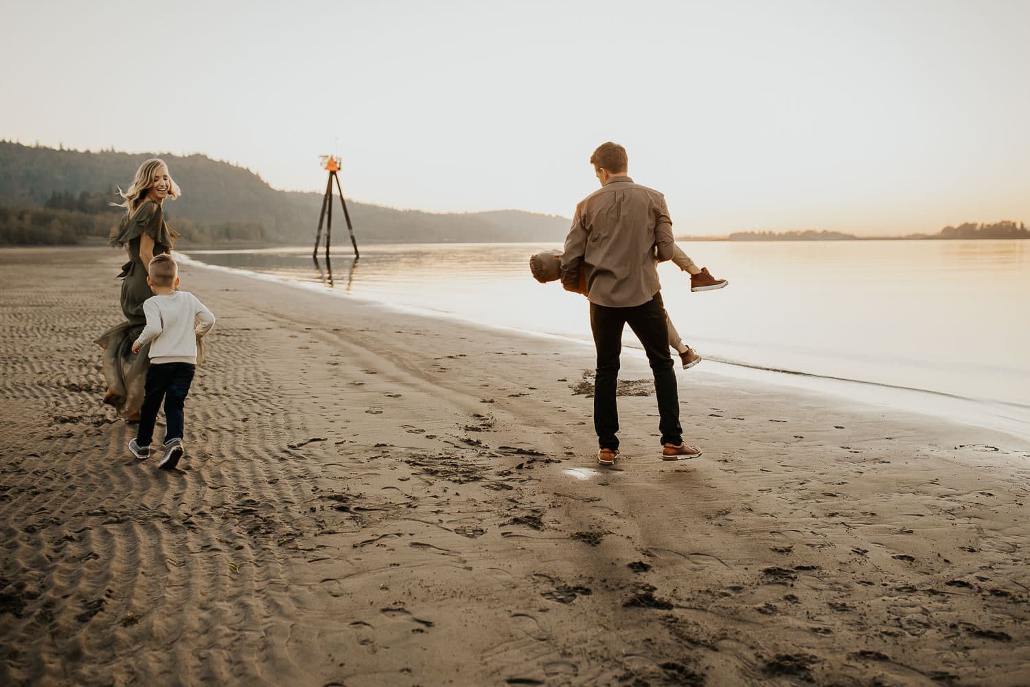 Family playing on river beach near portland Oregon