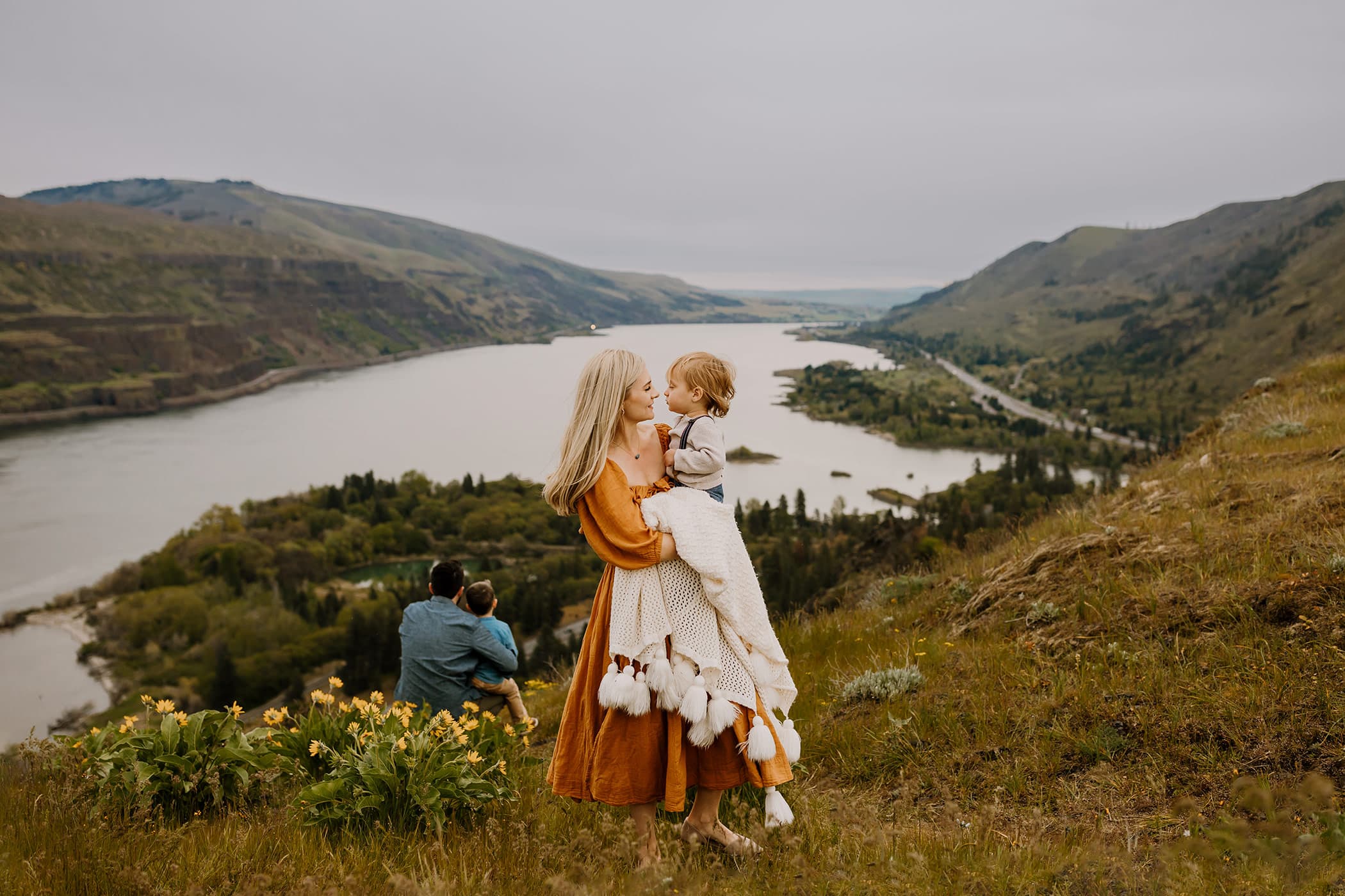 Mom hugging son in front of yellow wildflowers during photography session in the columbia river gorge near Mosier, Oregon