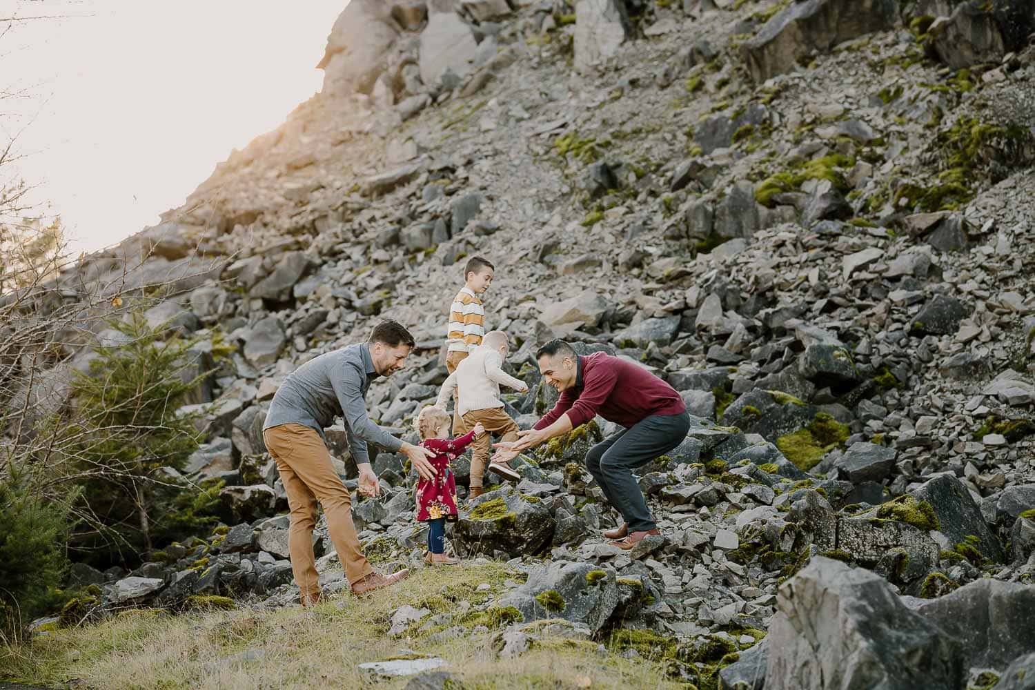Two dads playing on rocks with their three kids - Portland Oregon portrait photographer
