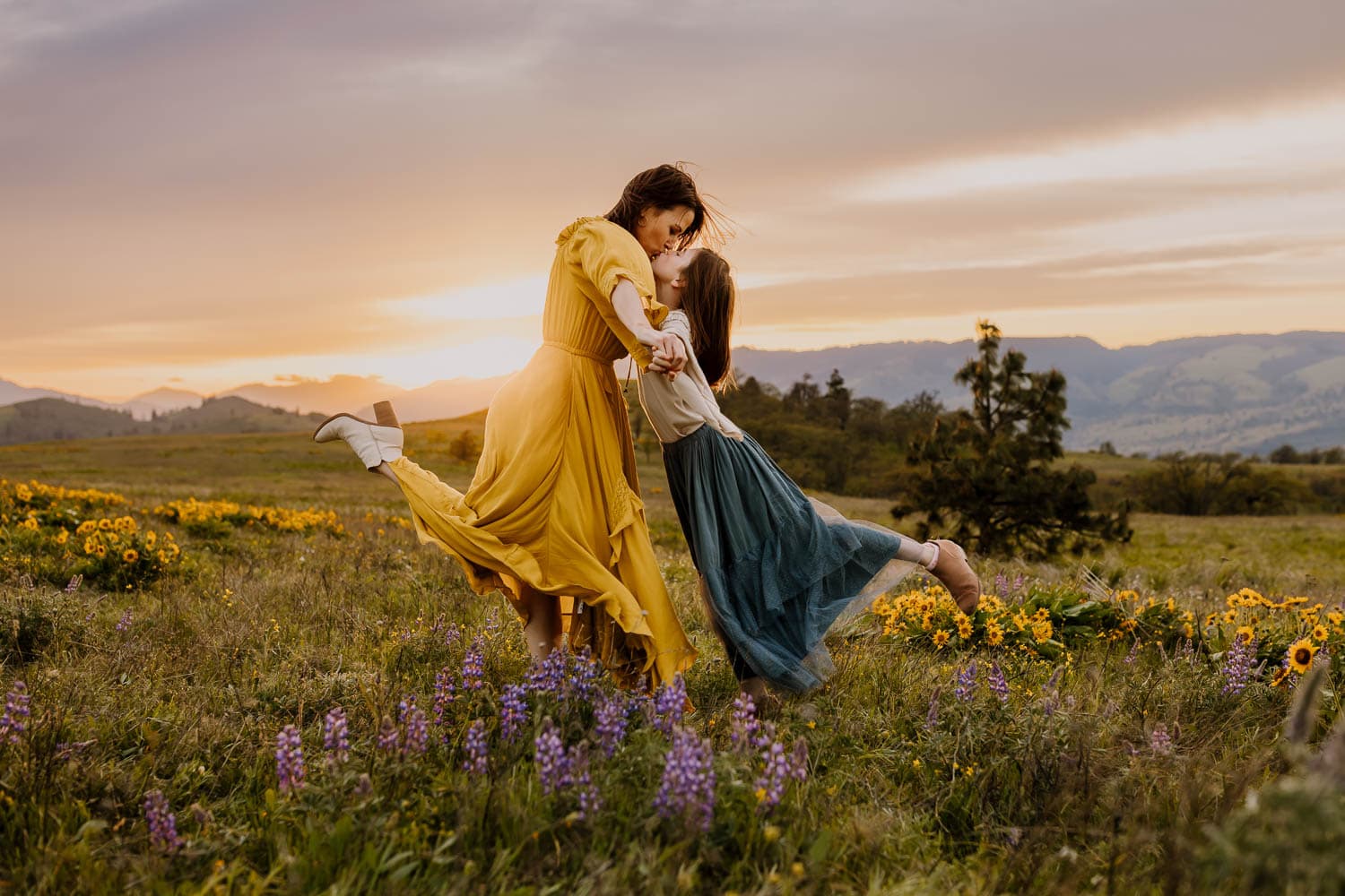 Mom and daughter dancing in wildflowers in Oregon