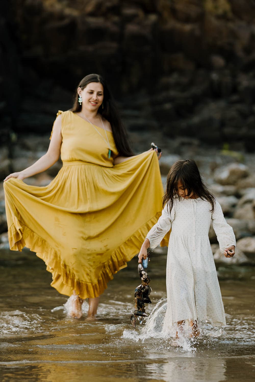 Mom holding her yellow dress from Joyfolie during family photo session