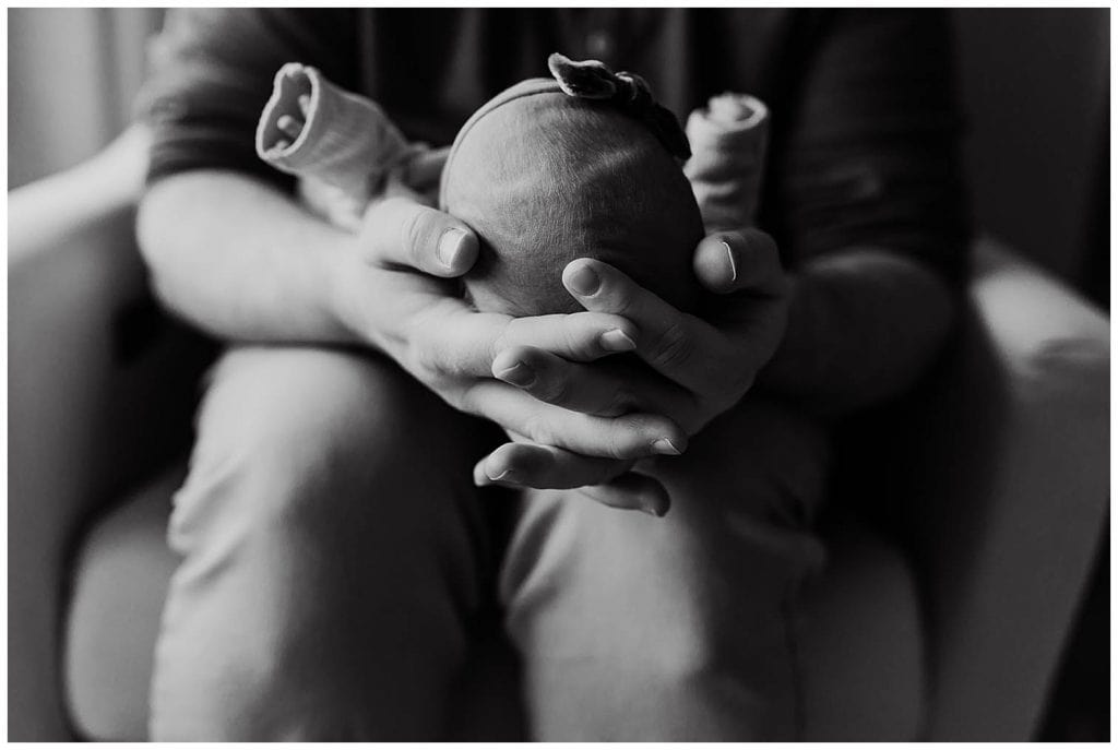 black and white photo of dad holding newborn during lifestyle photos in portland oregon
