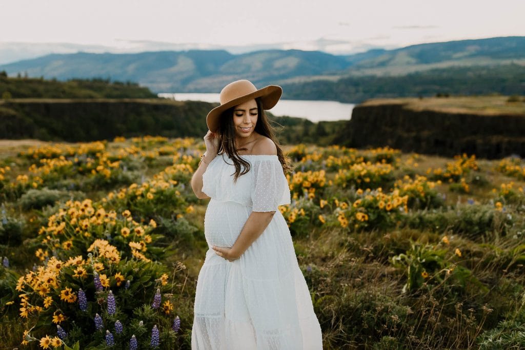 Maternity photo of mom in a white off the shoulder maxi dress from baltic born