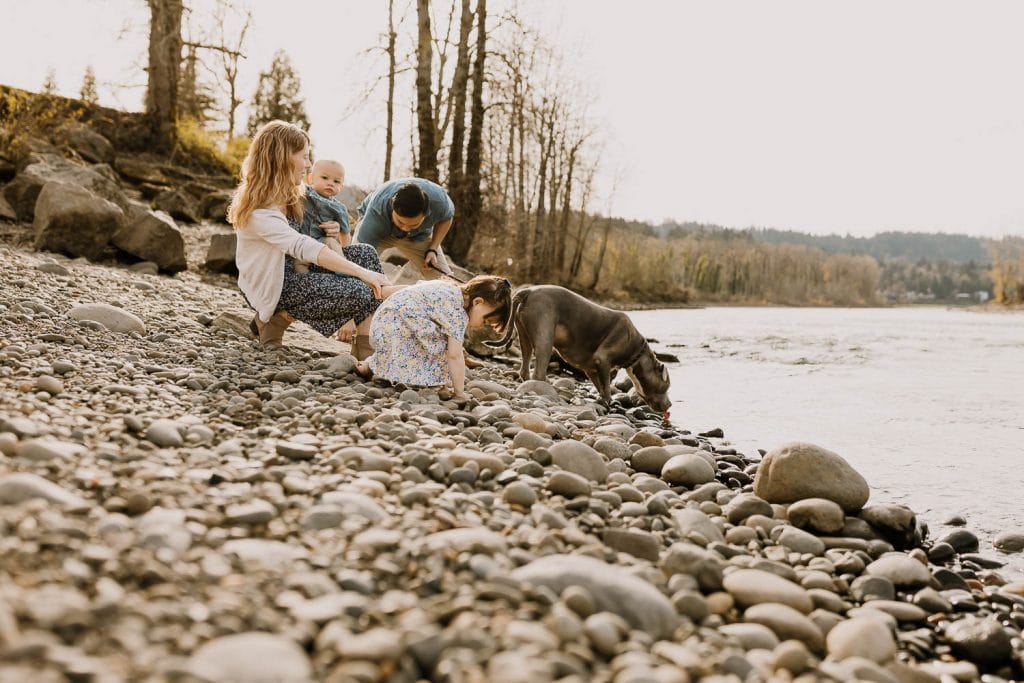 family with dog by river during family photos