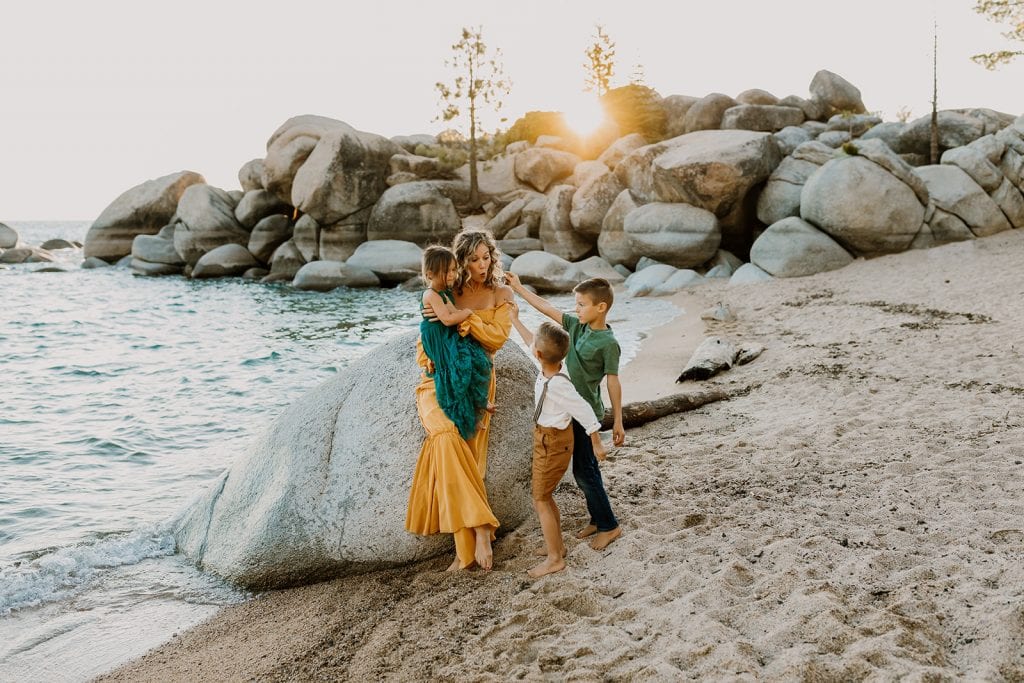 family showing off the rocks they found in Lake Tahoe, Nevada during travel photo session