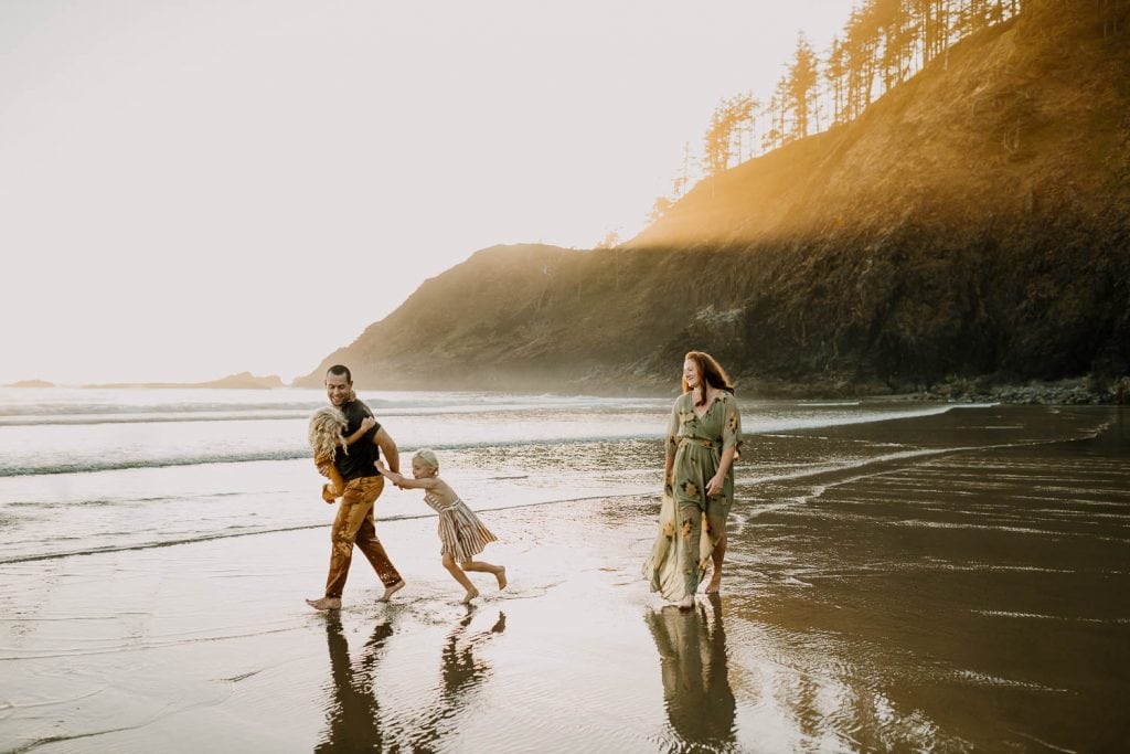 Oregon coast travel photo session with family of four playing on the beach