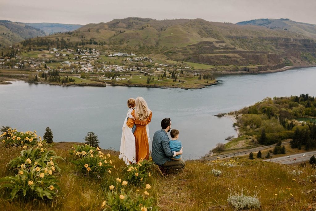 Family of four gazing at the Scenery of the Columbia River Gorge during wildflower season