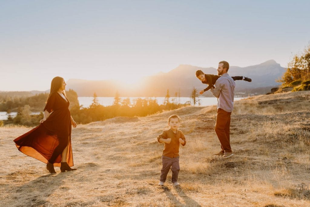 Family of four dancing in the columbia river gorge
