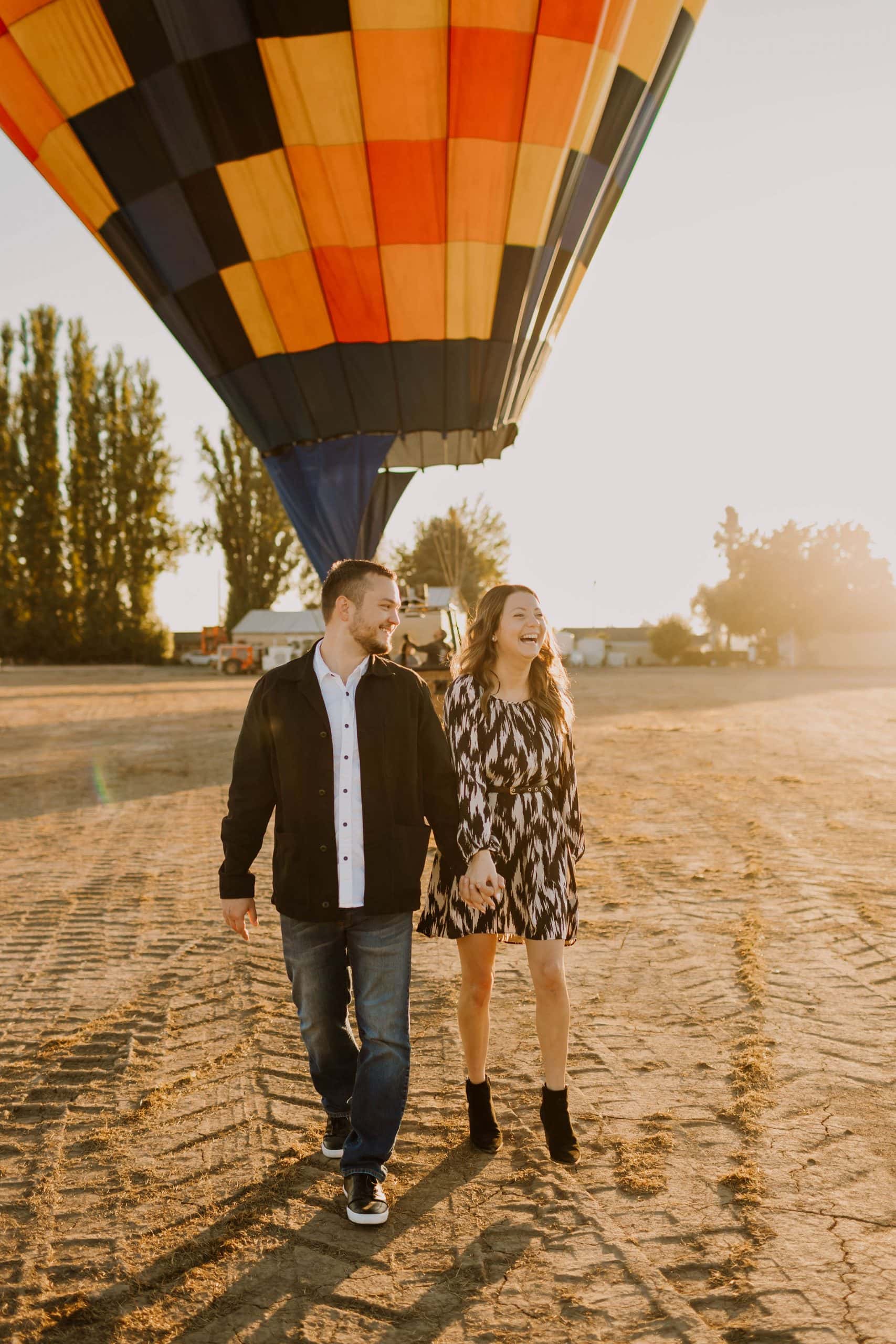 newly engaged couple near vancouver washington with hot air balloon behind them