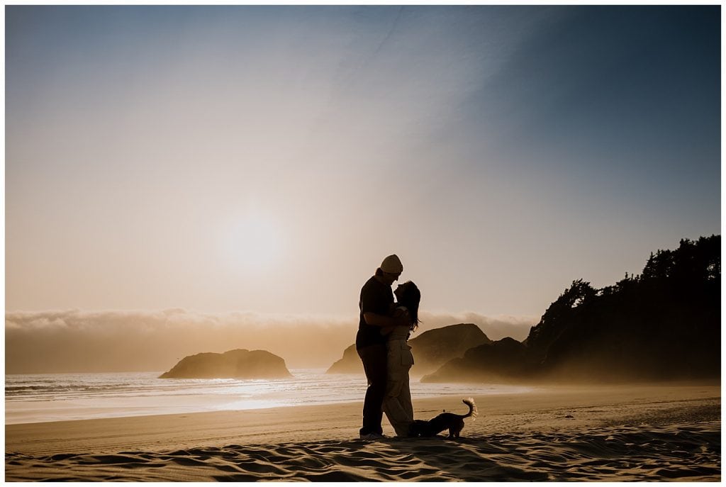 silhouette of a couple at cannon beach