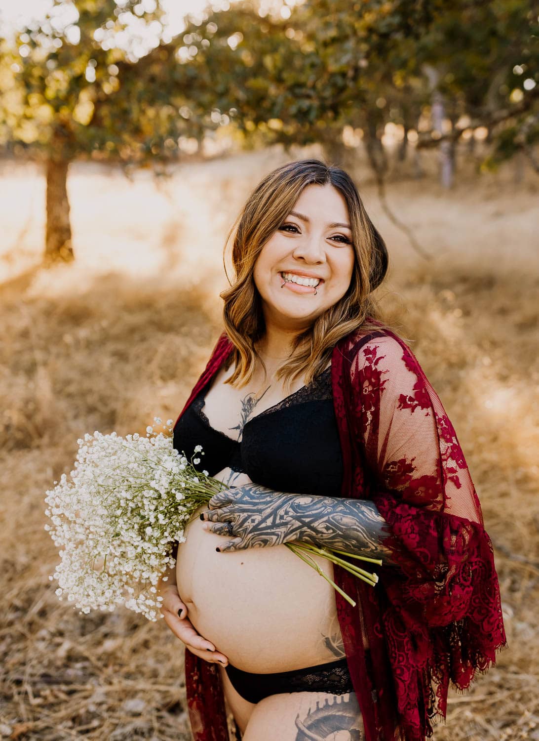 pregnant woman with tattoos laughing